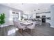 Elegant dining area with a modern table set, stylish chairs, and open access to a well-equipped kitchen at 321 Lasso Dr, Kissimmee, FL 34747