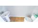 A clean half bath offers a pedestal sink, toilet, and neutral earth tone tile flooring at 321 Lasso Dr, Kissimmee, FL 34747