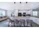 Well-lit kitchen featuring modern barstool seating at the breakfast bar, white cabinets, and an adjacent comfortable living space at 321 Lasso Dr, Kissimmee, FL 34747