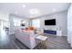 Bright, modern living room featuring stylish furniture, sleek flooring, and a contemporary fireplace with blue ambient lighting at 321 Lasso Dr, Kissimmee, FL 34747