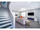 Open concept living area with modern fireplace and gray flooring at 321 Lasso Dr, Kissimmee, FL 34747