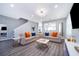 Beautiful living room with wood floors, contemporary furnishings, and a view into the kitchen and dining area at 321 Lasso Dr, Kissimmee, FL 34747