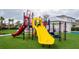 Community playground with colorful slides, climbing structures, and soft, safe turf at 321 Lasso Dr, Kissimmee, FL 34747