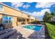 Backyard oasis features private pool, patio with lounge seating, and lush green landscaping at 321 Lasso Dr, Kissimmee, FL 34747