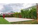 Sandy volleyball court surrounded by artificial grass, lush greenery, and bamboo at 321 Lasso Dr, Kissimmee, FL 34747