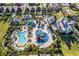 Aerial view of community water park featuring pools, waterslides, and splash pads for Gathering fun at 321 Lasso Dr, Kissimmee, FL 34747