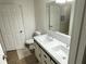 Bright bathroom with a double vanity, white cabinets, and modern fixtures at 3301 Soho St # 104, Orlando, FL 32835