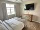 Bedroom view of a mounted television and modern furniture at 3301 Soho St # 104, Orlando, FL 32835