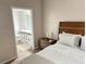 Cozy bedroom with wood floors and view of the en suite bathroom at 3301 Soho St # 104, Orlando, FL 32835