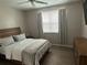Bright bedroom with natural light, neutral tones, and ceiling fan at 3301 Soho St # 104, Orlando, FL 32835