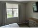 Bedroom view of a large window and modern furniture at 3301 Soho St # 104, Orlando, FL 32835