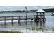 View of covered pier offering a peaceful waterfront retreat with views of the surrounding landscape at 3301 Soho St # 104, Orlando, FL 32835