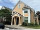Two-story home with peach siding, white trim, and a black front door at 3301 Soho St # 104, Orlando, FL 32835