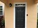 Up close shot of the black front door with white trim and the house number at 3301 Soho St # 104, Orlando, FL 32835