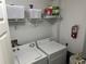 Functional laundry room with washer, dryer, and shelving for storage at 3301 Soho St # 104, Orlando, FL 32835