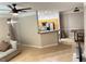 Spacious living room, open to the kitchen, with tile flooring and a sectional couch at 3301 Soho St # 104, Orlando, FL 32835