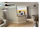 Open-concept living room with a ceiling fan flowing into the kitchen and dining area at 3301 Soho St # 104, Orlando, FL 32835