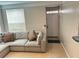 Living room with a large sectional couch, tile flooring, and plenty of natural light at 3301 Soho St # 104, Orlando, FL 32835
