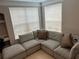 Corner nook with a gray sectional sofa providing a cozy spot to relax at 3301 Soho St # 104, Orlando, FL 32835