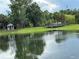 Picturesque pond featuring a gazebo and a charming bridge, enhancing the community's appeal at 3301 Soho St # 104, Orlando, FL 32835