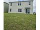Expansive backyard view with sliding door entry, lush green lawn, and minimal landscaping at 3886 Whitney Way, Haines City, FL 33844