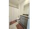 Cozy bathroom featuring a shower with a curtain, granite countertops and gray cabinets at 3886 Whitney Way, Haines City, FL 33844