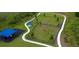 Aerial view of community dog park with play structures, walking path and designated areas for large and small breeds at 3886 Whitney Way, Haines City, FL 33844