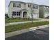 Two story home with a two car garage, manicured lawn, and a well maintained landscape at 3886 Whitney Way, Haines City, FL 33844