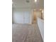 Bright hallway with neutral carpet, white walls, and classic paneled doors with a view to another room at 3886 Whitney Way, Haines City, FL 33844