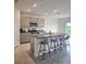 Bright kitchen with granite countertops, a large island, stainless steel appliances, and light gray cabinets at 3886 Whitney Way, Haines City, FL 33844
