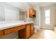 Spacious bathroom featuring an extended vanity, storage cabinets, and neutral tile flooring at 4215 Red Bird Ave, St Cloud, FL 34772