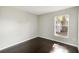 Cozy bedroom with hardwood floors, a window bringing in natural light, and neutral walls at 4215 Red Bird Ave, St Cloud, FL 34772