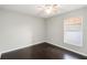 Comfortable bedroom with hardwood floors, a ceiling fan and a bright window at 4215 Red Bird Ave, St Cloud, FL 34772