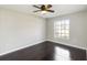 Comfortable bedroom with hardwood floors, a ceiling fan and a large window at 4215 Red Bird Ave, St Cloud, FL 34772