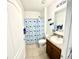 Bright bathroom featuring a whale-themed shower curtain, granite vanity, and modern fixtures at 4250 Roberta Dr, Winter Haven, FL 33881