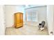Bright bedroom with tiled flooring, a window, and an armoire, with neutral walls at 4250 Roberta Dr, Winter Haven, FL 33881