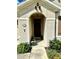 Inviting front entrance with an arched doorway, decorative elements, and manicured greenery at 4250 Roberta Dr, Winter Haven, FL 33881
