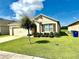 Beautiful single-story home with lush green lawn, complemented by mature landscaping at 4250 Roberta Dr, Winter Haven, FL 33881