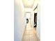 Bright hallway with tile flooring leads to the bathroom and a closet at 4250 Roberta Dr, Winter Haven, FL 33881