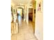 Open hallway featuring tiled flooring, decorative niches, and doorways leading to other rooms at 4250 Roberta Dr, Winter Haven, FL 33881