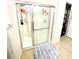 Modern shower stall with sliding glass door, storage shelves and shower head at 4250 Roberta Dr, Winter Haven, FL 33881