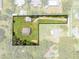 Aerial view of the property and surrounding area with mature trees bordering the lot at 431 Eastern Ave, St Cloud, FL 34769