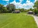 Aerial view of the home with a spacious green lawn and a detached garage at 431 Eastern Ave, St Cloud, FL 34769