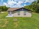 The rear of the single story home has a small porch and well-maintained lawn at 431 Eastern Ave, St Cloud, FL 34769