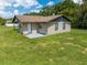 The back of this single story home features a small covered porch and pristine lawn at 431 Eastern Ave, St Cloud, FL 34769