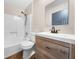 Bathroom featuring a stylish wood vanity, modern fixtures, and a shower-tub combo at 431 Eastern Ave, St Cloud, FL 34769