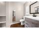 Bathroom featuring a stylish wood vanity, modern fixtures, and a modern mirror at 431 Eastern Ave, St Cloud, FL 34769