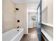 Stylish bathroom featuring a shower-tub, tile walls, modern fixtures, and tile floors at 431 Eastern Ave, St Cloud, FL 34769
