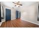 Bright bedroom featuring sleek hardwood floors, ceiling fan, and neutral wall colors at 431 Eastern Ave, St Cloud, FL 34769