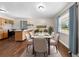 Bright dining area featuring hardwood floors, neutral walls, and an adjacent island at 431 Eastern Ave, St Cloud, FL 34769